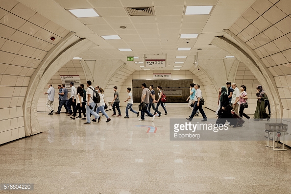Travelers walk inside the Marmaray commuter train station in Istanbul, Turkey, on Sunday, July, 17, 2016. The Turkish government moved swiftly to calm investors before financial markets reopen Monday after a failed coup, with the central bank promising unlimited liquidity to banks and the deputy prime minister reaching out to international investors. Photographer: Ismail Ferdous/Bloomberg