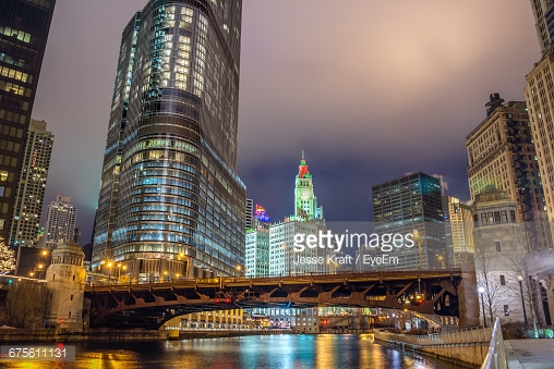View of the Chicago River and skyscrapers in downtown Chicago as seen at night